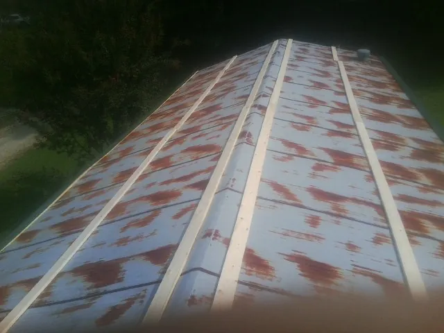 Rusted metal roof panels with new wood purlins before replacement — Storm Damage Roof Repair in Warner Springs by Roofing Brothers