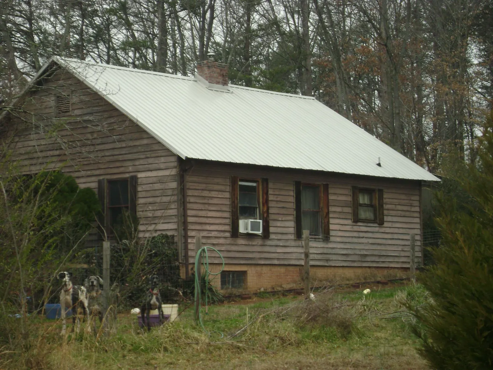 White metal roof on an old wood sided farmhouse, from a Metal Roof Installation job in Warner Springs